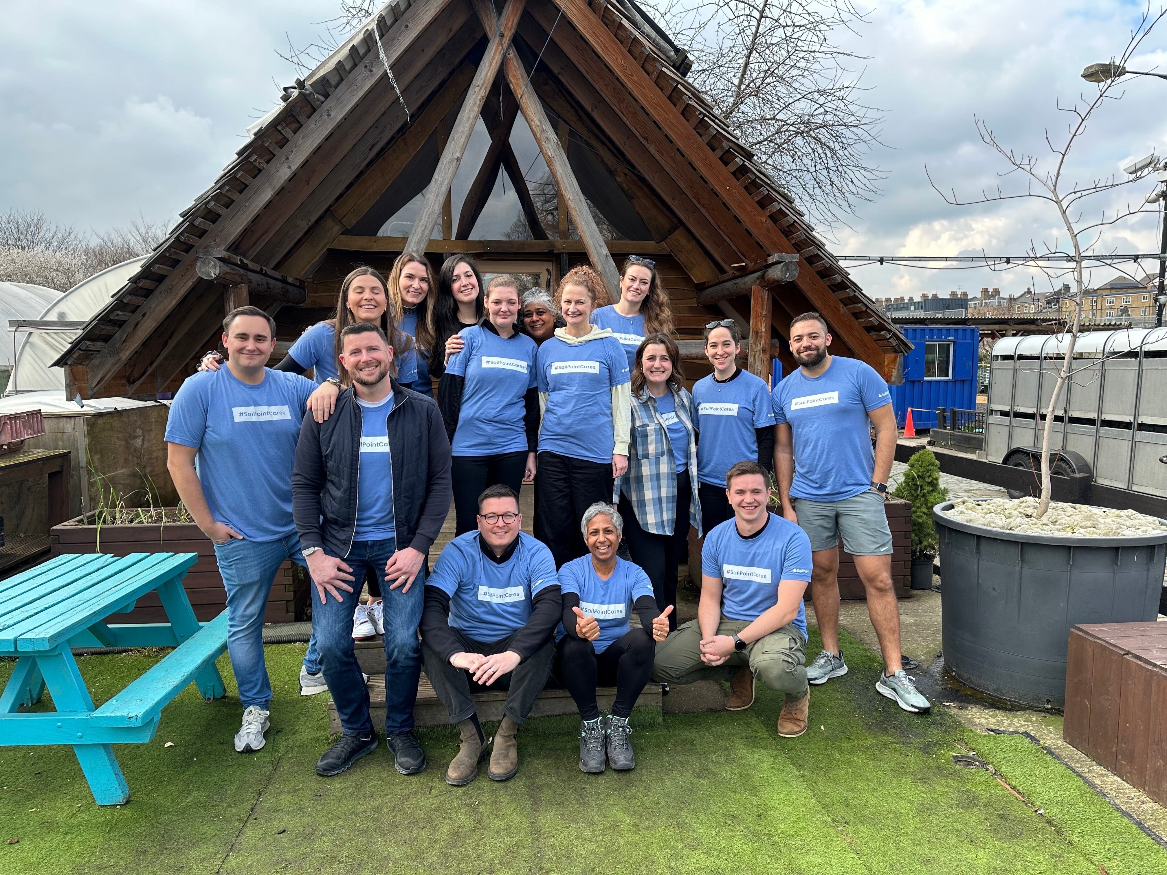 A group of 15 SailPoint team members in company-branded T-shirts that read “SailPointCares.”