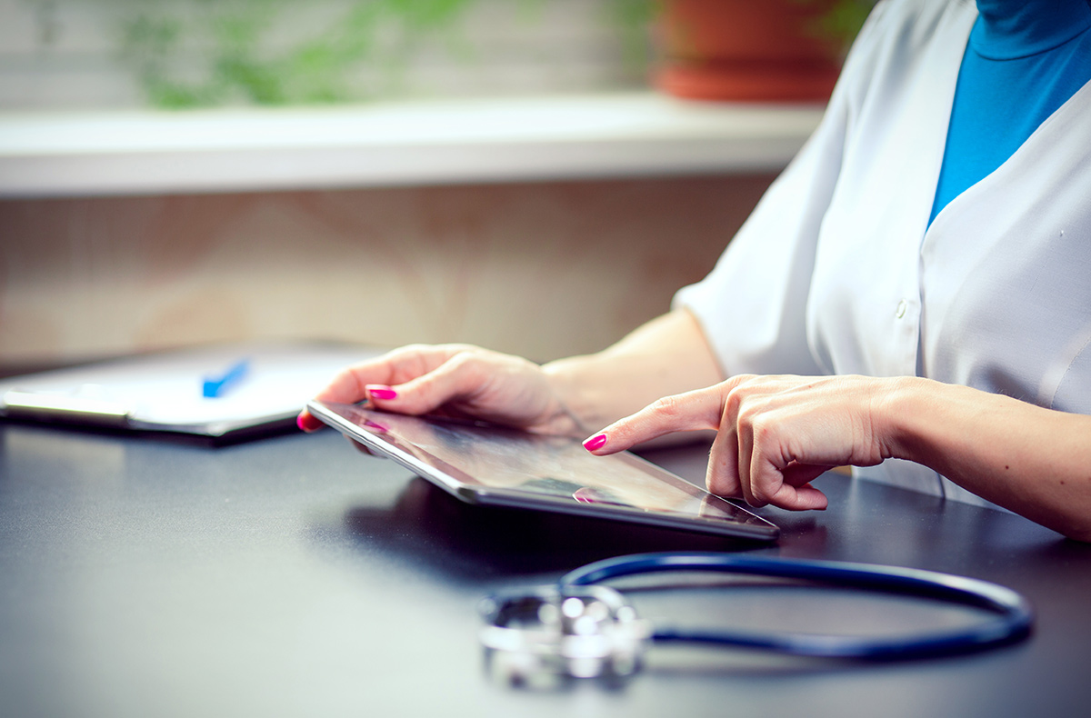 Woman doctor using tablet computer in a hospital