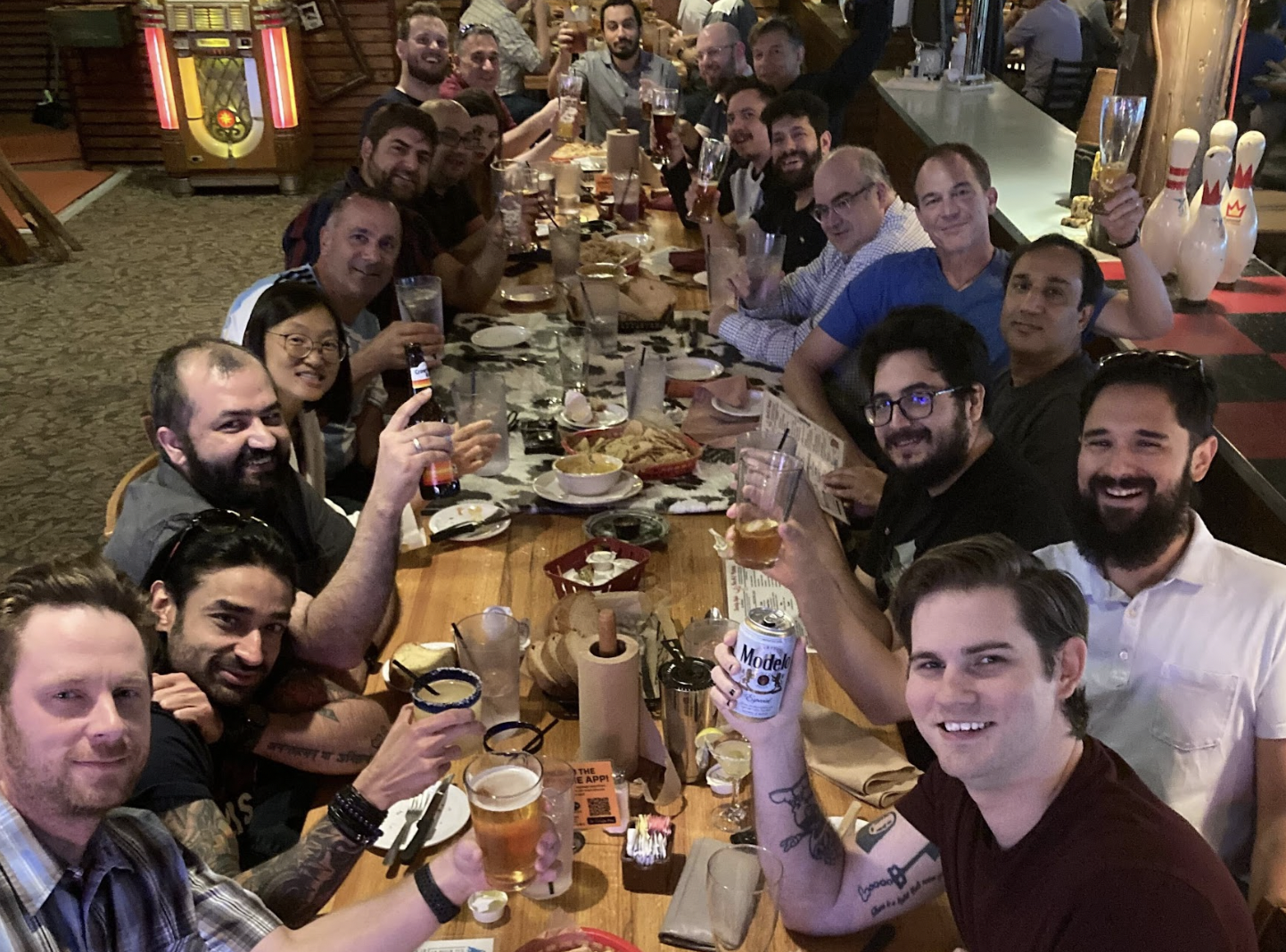 Brinqa team members gathered around a table at a restaurant