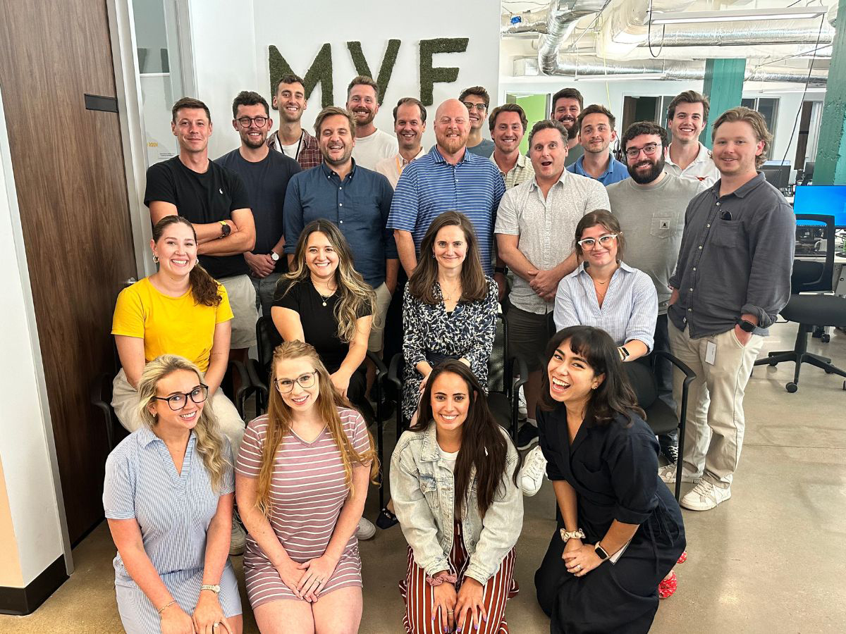 MVF Global team members pose for an in-office photo