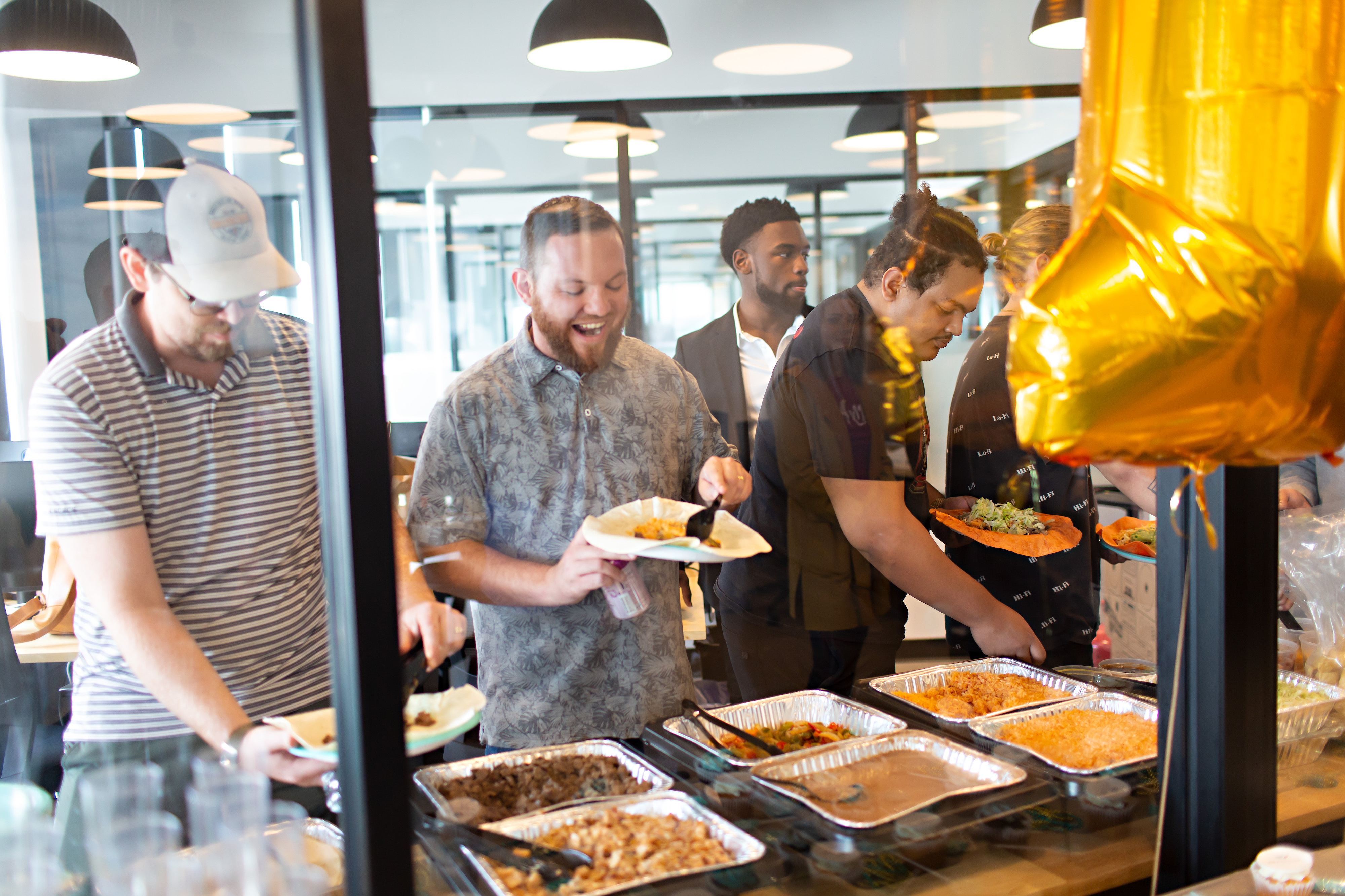 RealWork employees smile and laugh over food
