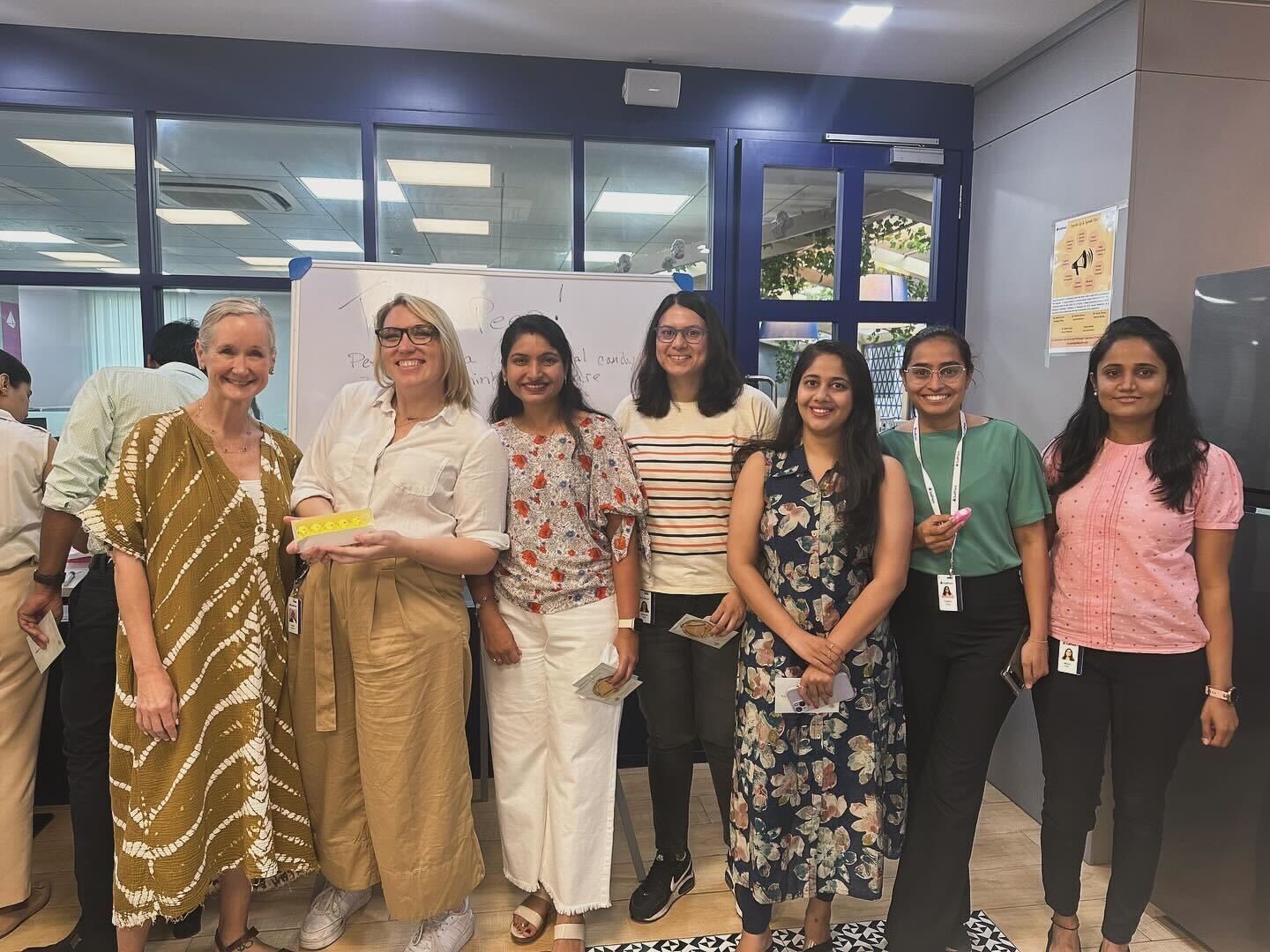 Seven SailPoint women team members pose for a photo in their office.