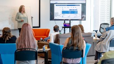 Woman presenting to room of people