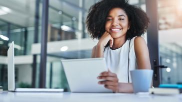 Cropped shot of a smiling young businesswoman working in her office.